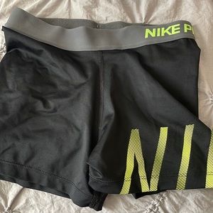 Black and neon yellow Nike pros